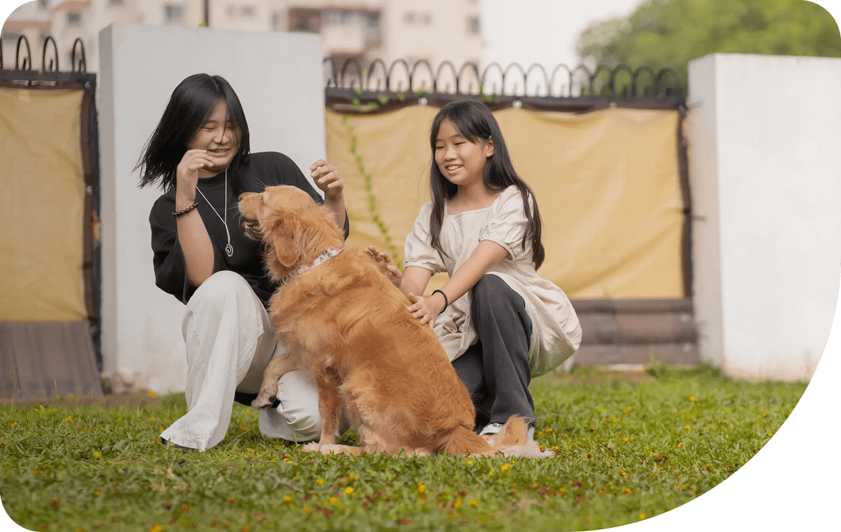 Smiling girls with a happy dog